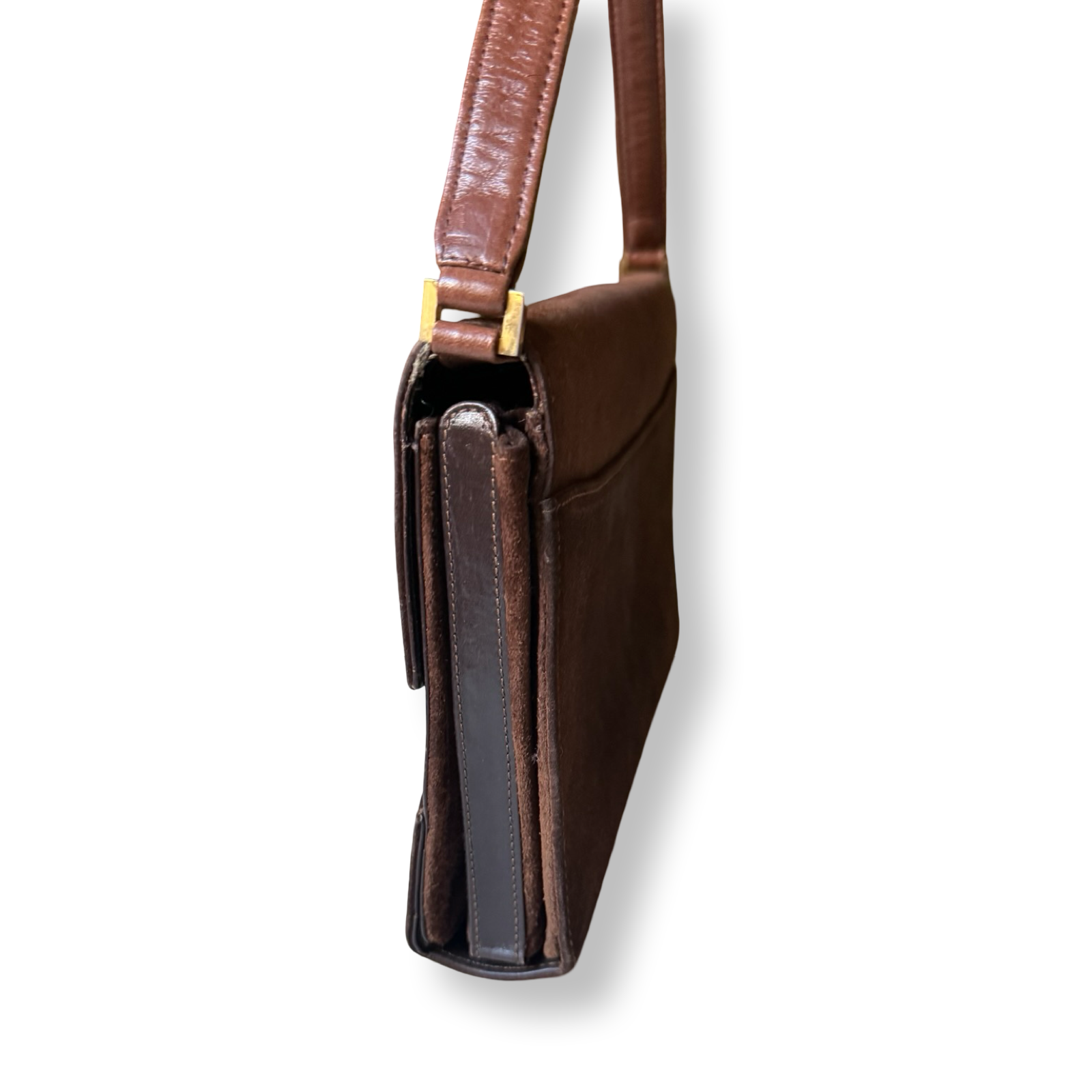 Brown leather bag with a strap on a white background