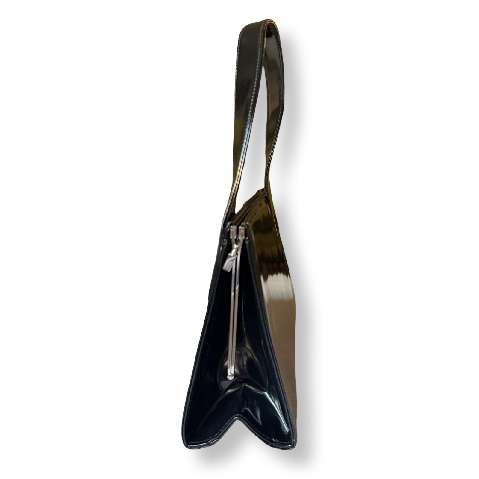 Black patent leather handbag with a long strap on a white background