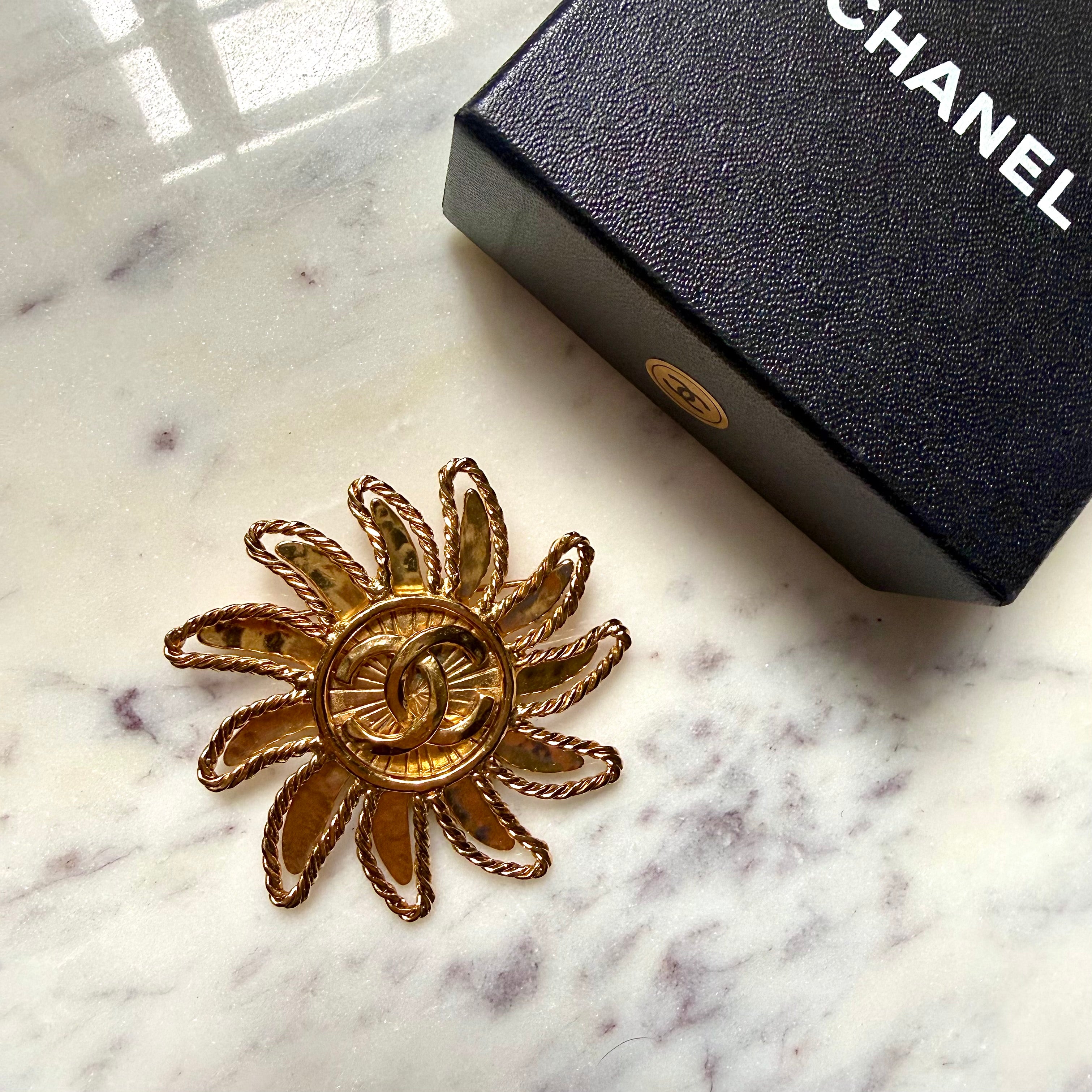 Authentic vintage Chanel Sun Brooch 1994 by Karl Lagerfeld Gold plated intricate design sun and Coco mark