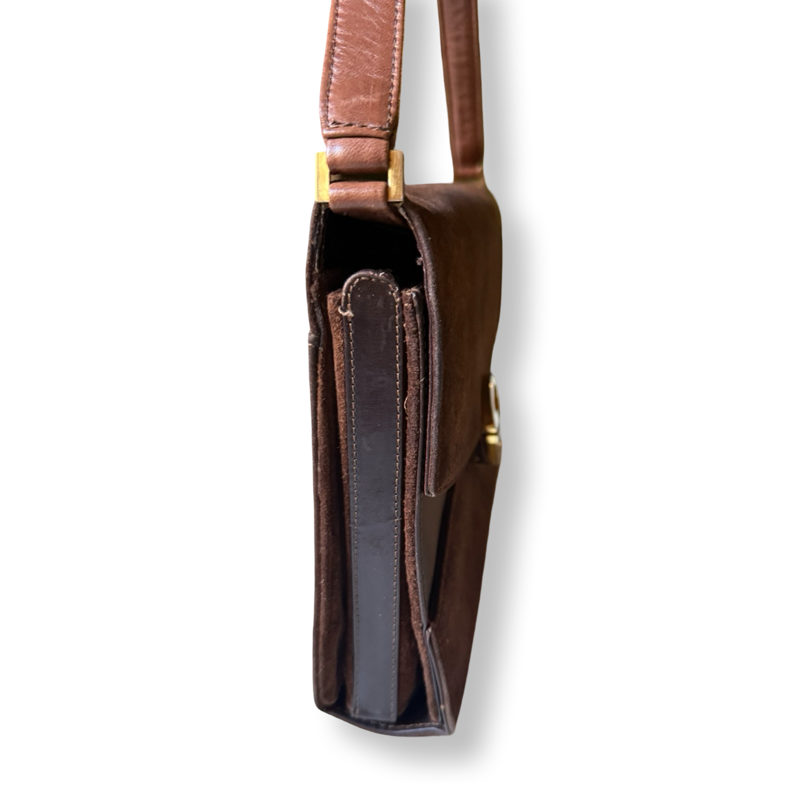 Brown leather bag with gold hardware on a white background